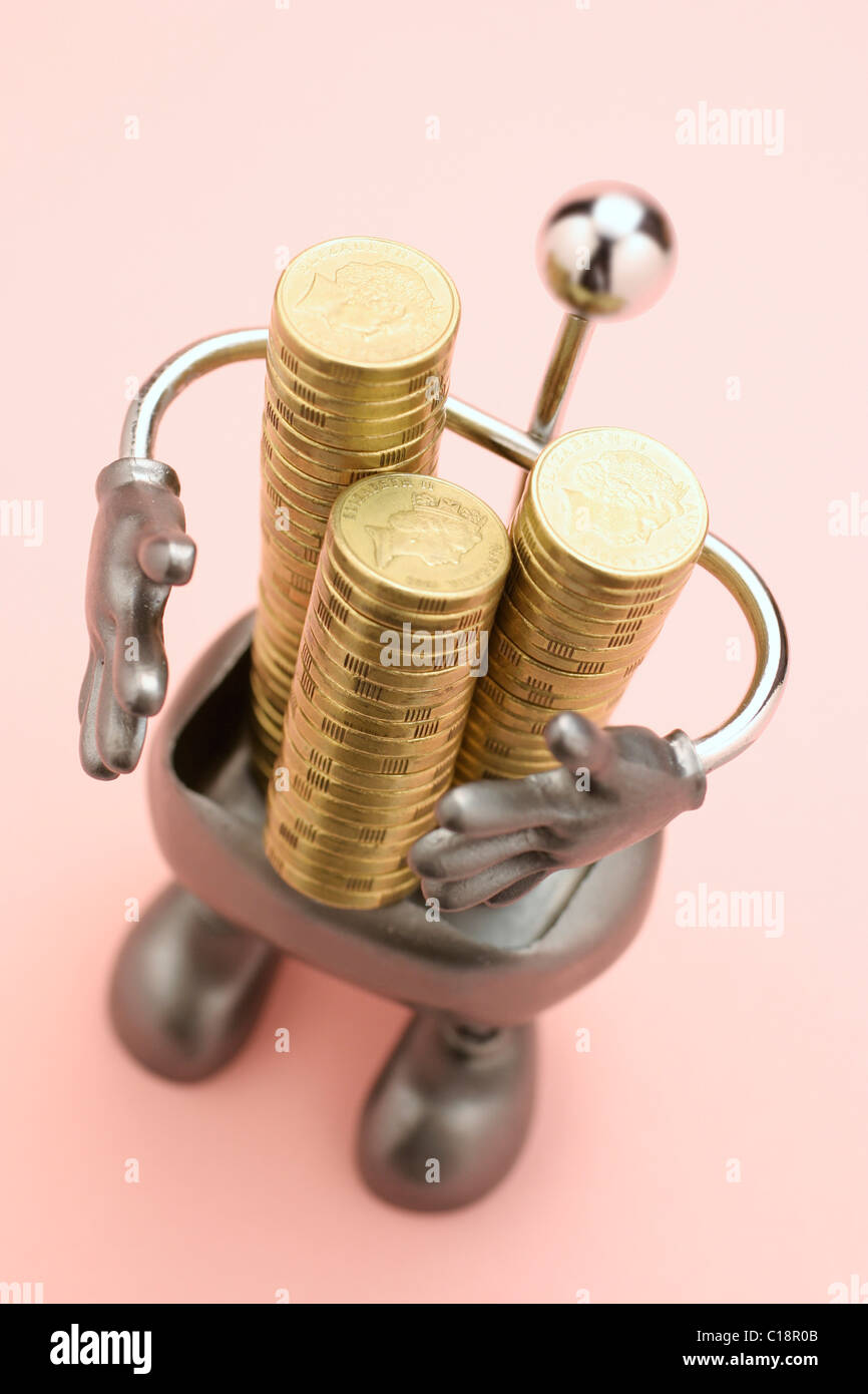 Stacks of coins in metal holder Stock Photo
