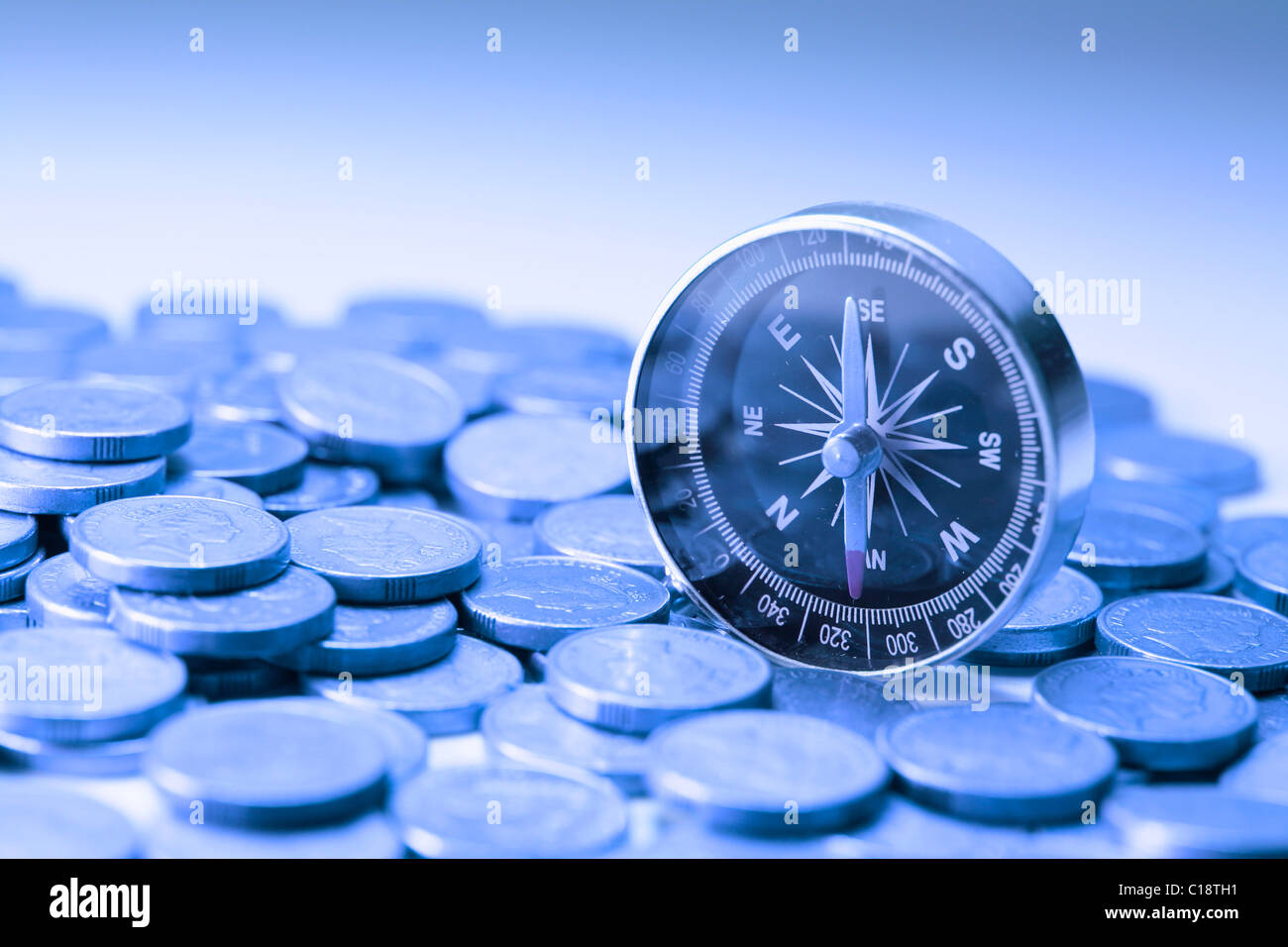 Coins and compass Stock Photo Alamy