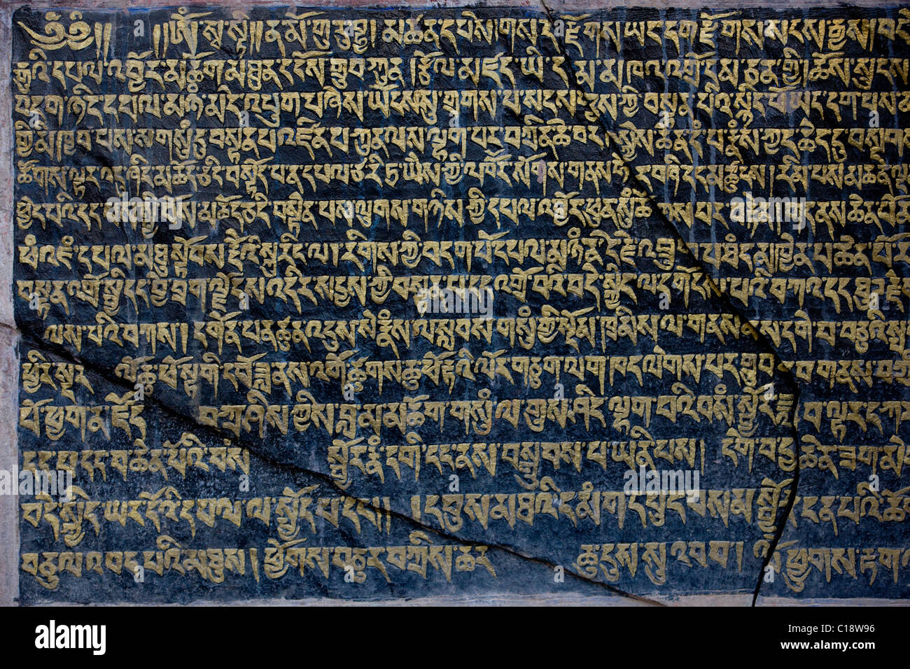 Tibetan script on cracked stone, Hemis Gompa, (Ladakh) Jammu & Kashmir, India Stock Photo