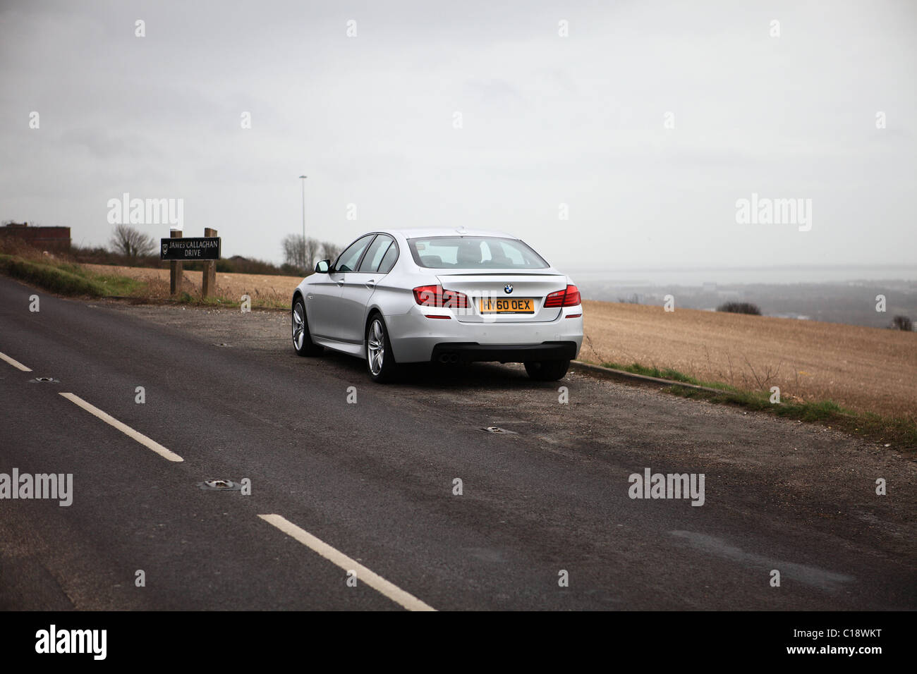 Silver BMW 5-Series Saloon Motor Car, F10 version introduced in November 2009, this is a January 2011 right-hand drive model. Stock Photo