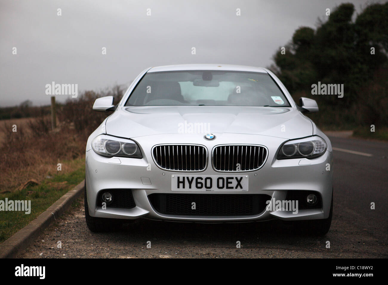 Silver BMW 5-Series Saloon Motor Car, F10 version introduced in November 2009, this is a January 2011 right-hand drive model. Stock Photo