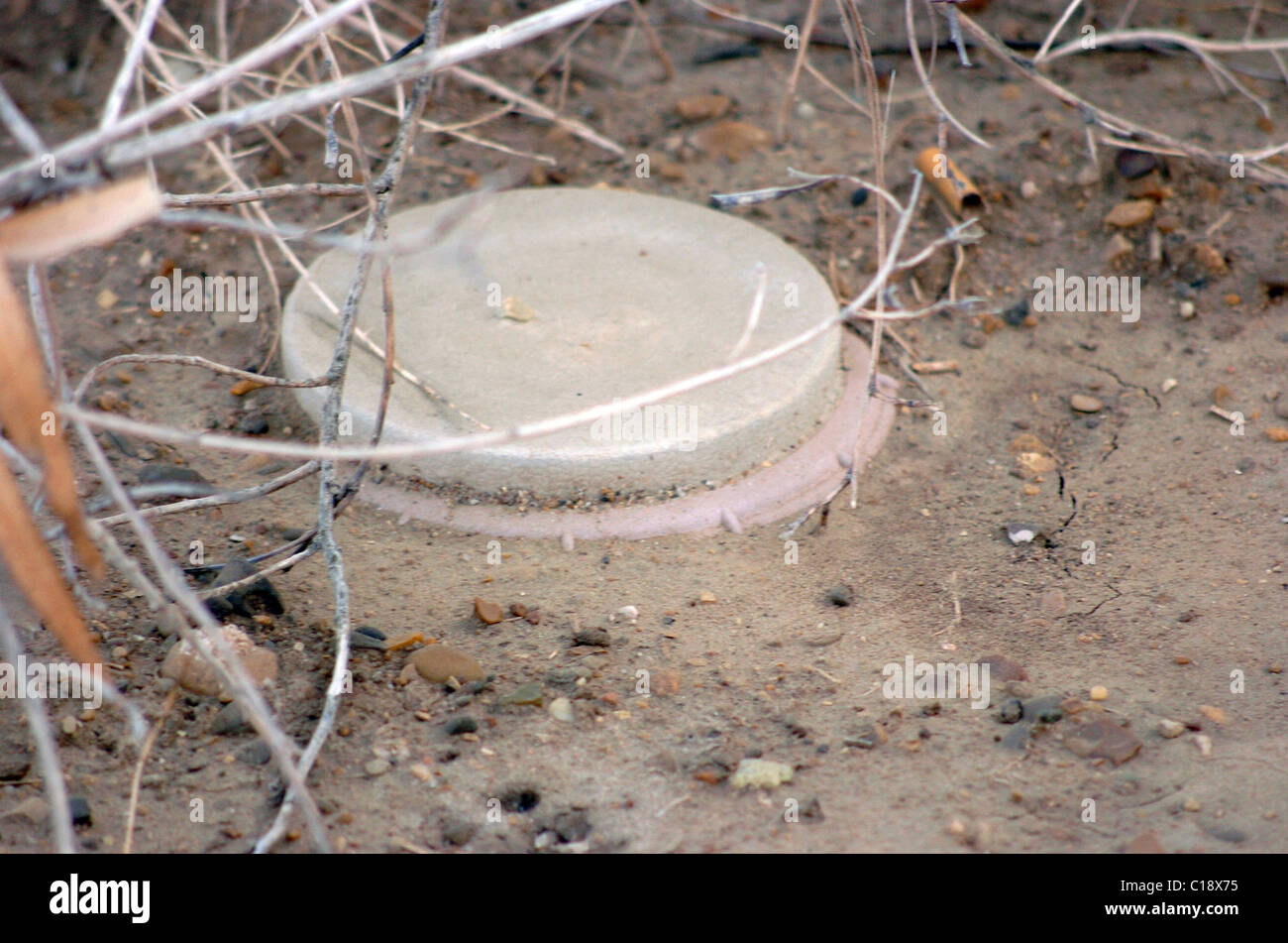 A land mine is a target (person or vehicle) triggered explosive weapon Stock Photo