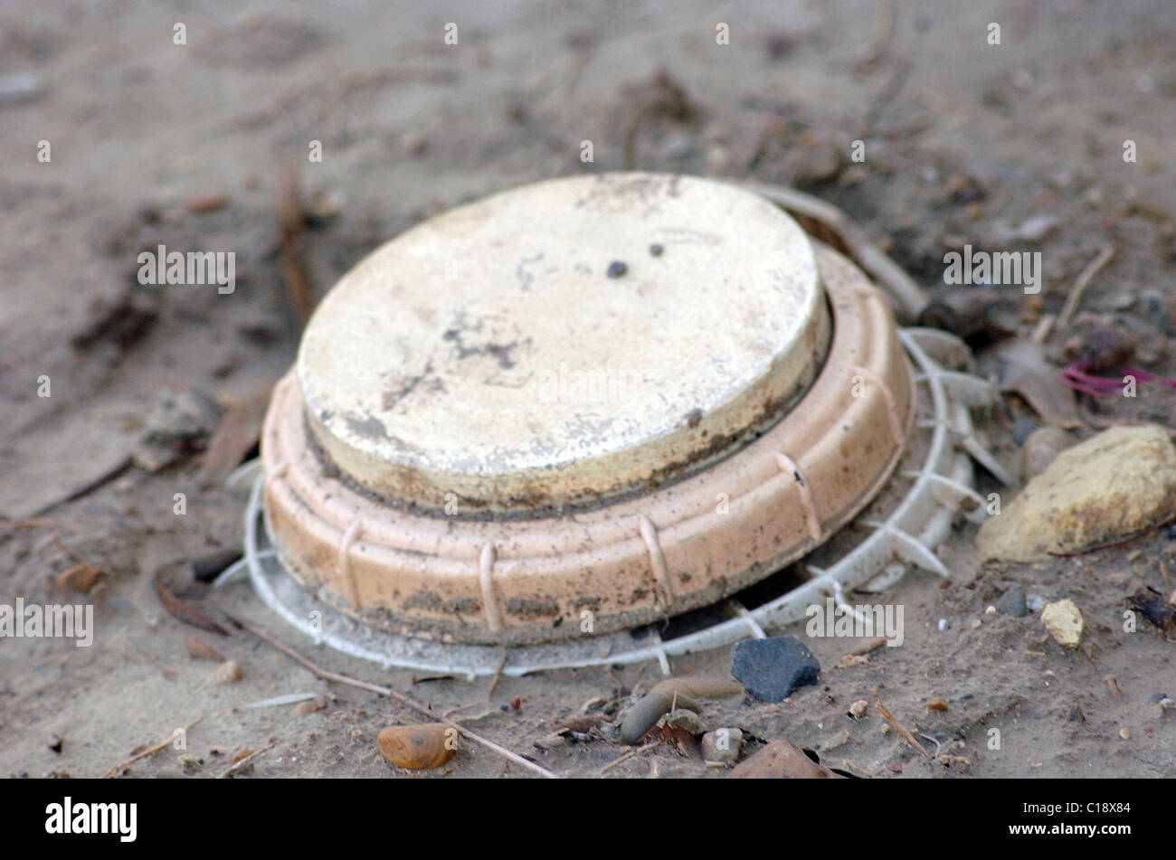 A land mine is a target (person or vehicle) triggered explosive weapon Stock Photo