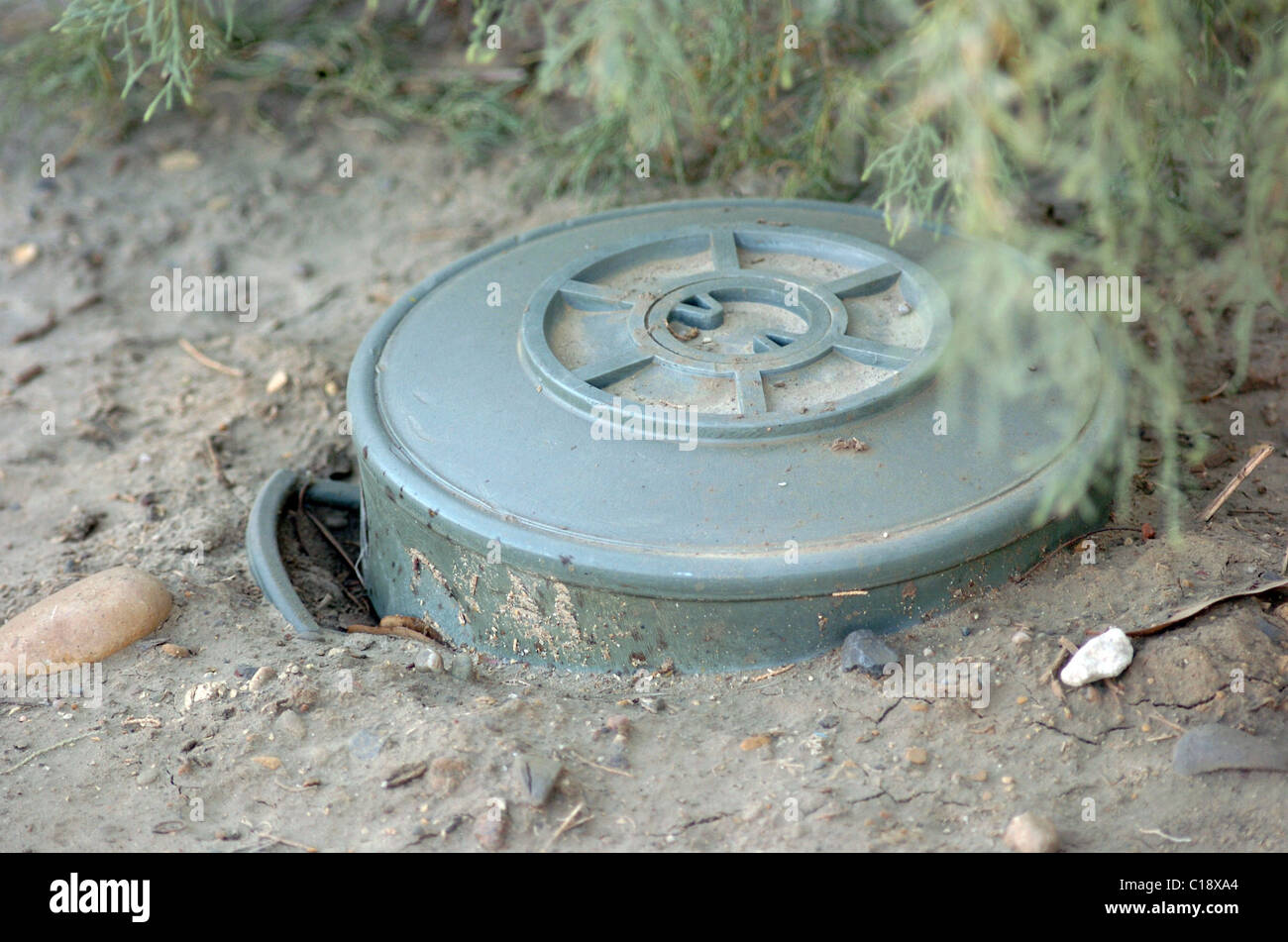 A land mine is a target (person or vehicle) triggered explosive weapon Stock Photo