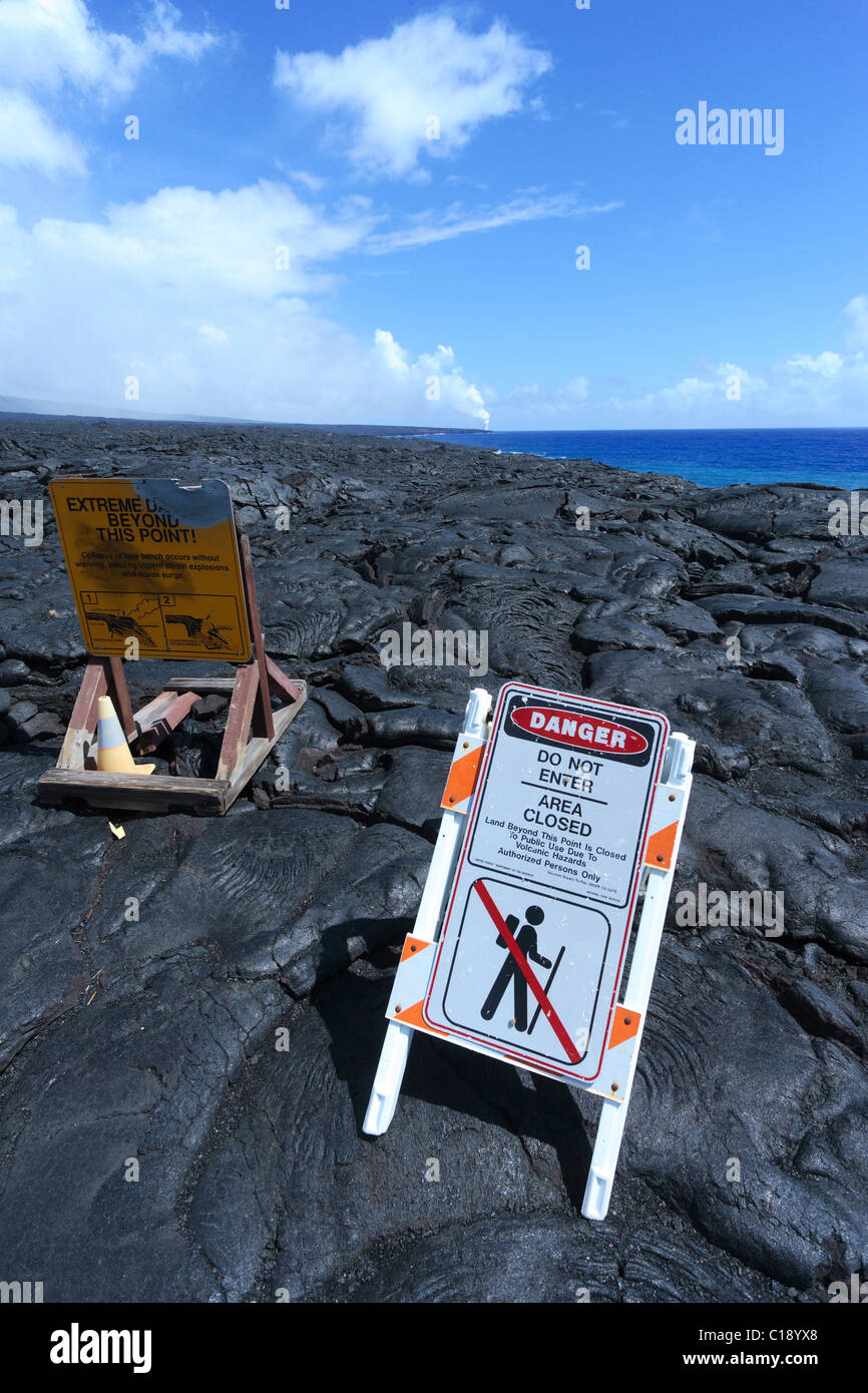 Cooled lava and warning signs in Volcano Park on the south coast of Big Island, Hawaii, USA Stock Photo
