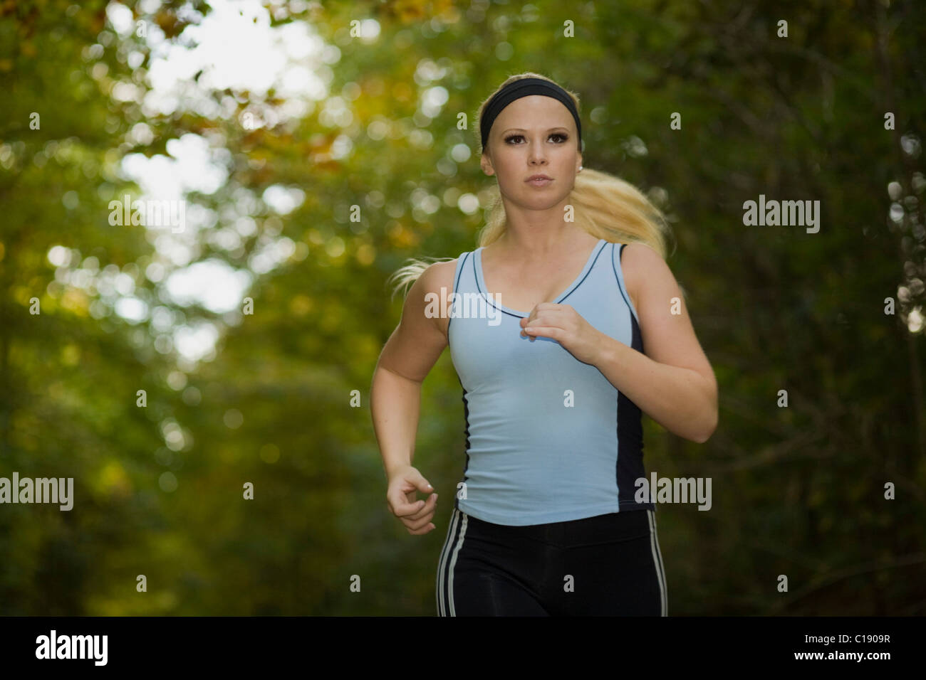 Young woman jogging in an autumnal forest Stock Photo