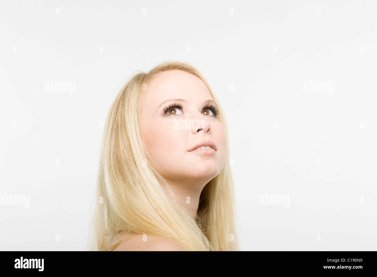 Young blonde woman looking up Stock Photo