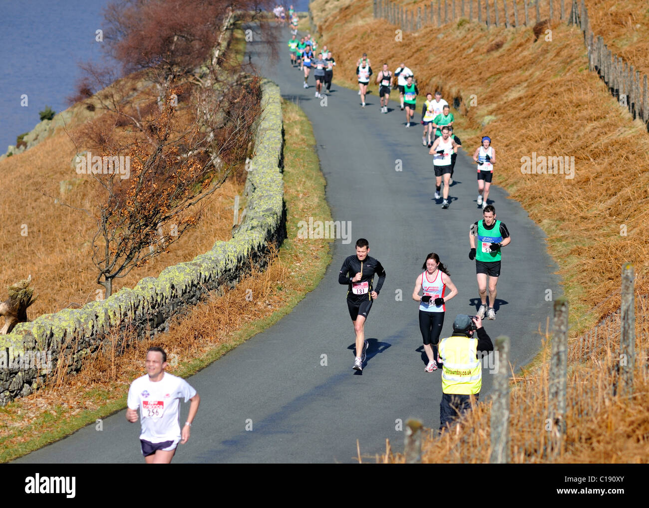 Capturing images of half-marathon competitors, Haweswater, Cumbria, England Stock Photo