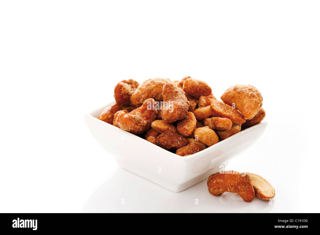 Cashew nuts with salt and honey in a white bowl Stock Photo
