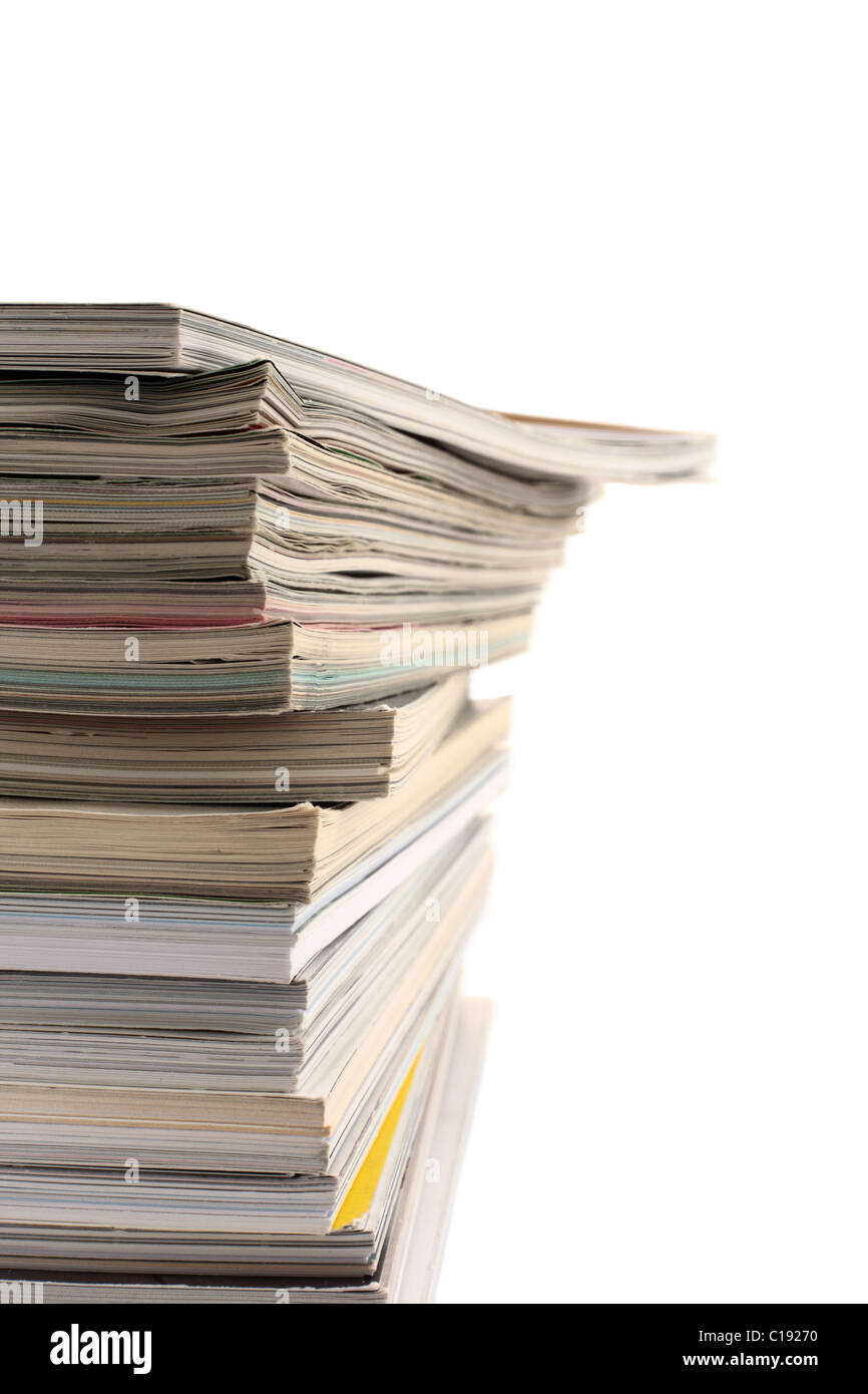 A pile of used magazines with empty copy space to the right. Stock Photo
