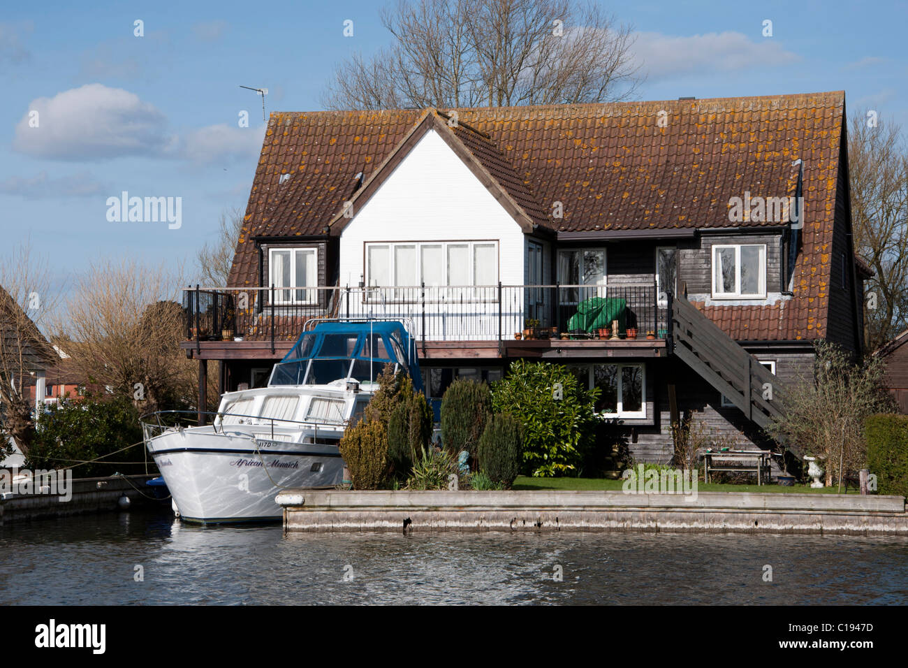 River front house with Boat parked River Bure Norfolk Broads Stock