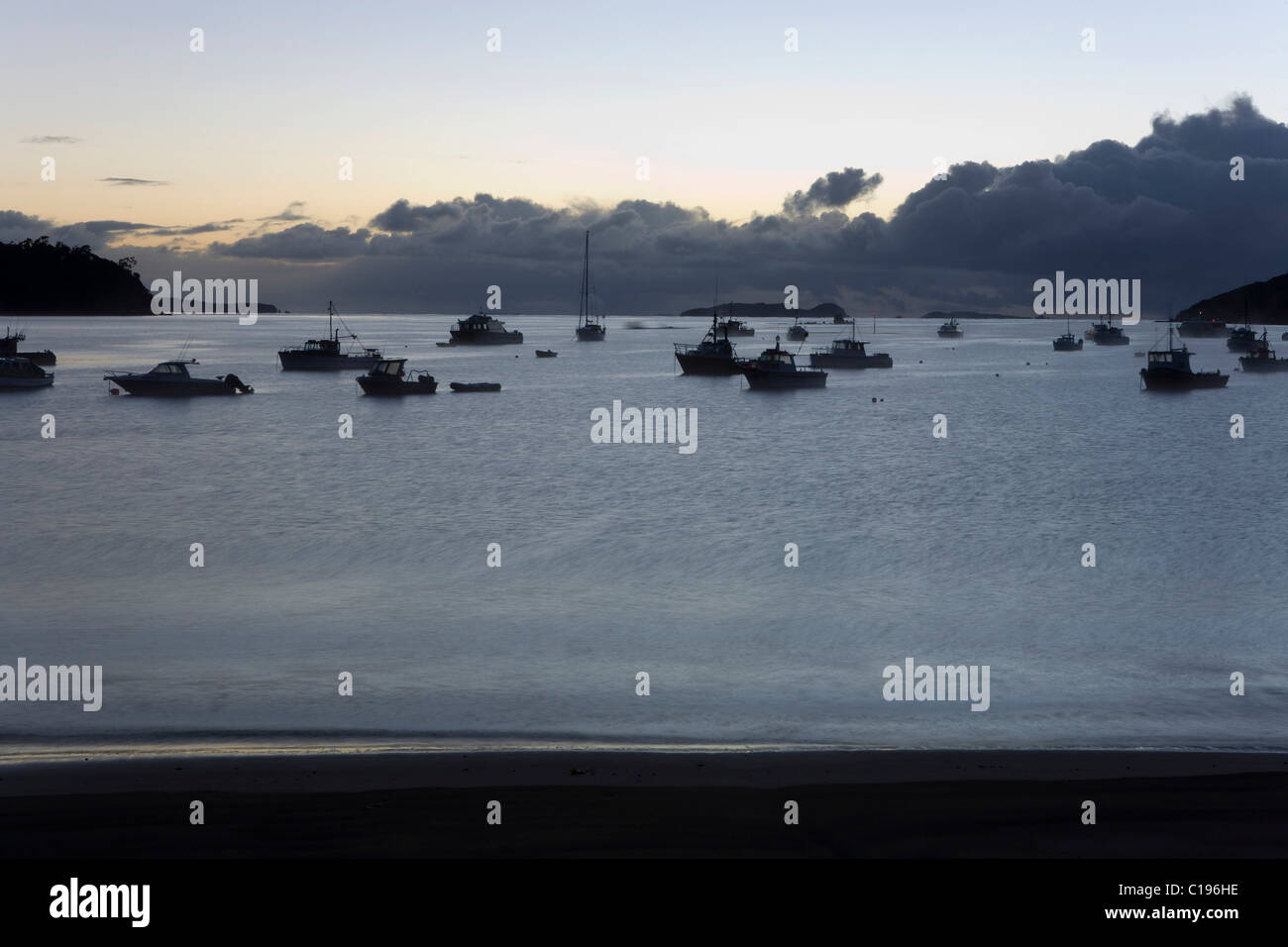 Boats in the grey of the morning, Halfmoon Bay, Steward Island, New Zealand Stock Photo