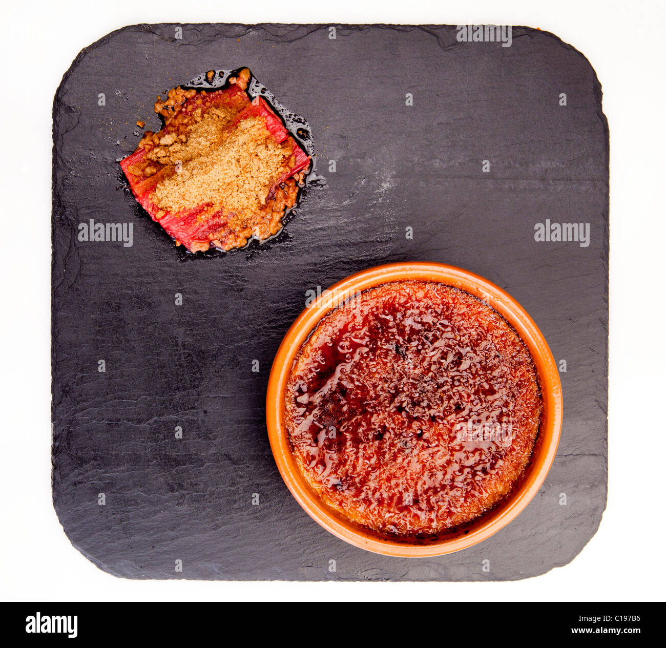 Dessert creme brulee with roasted rhubarb and star anise biscuit on a slate 116479 Food20 Stock Photo
