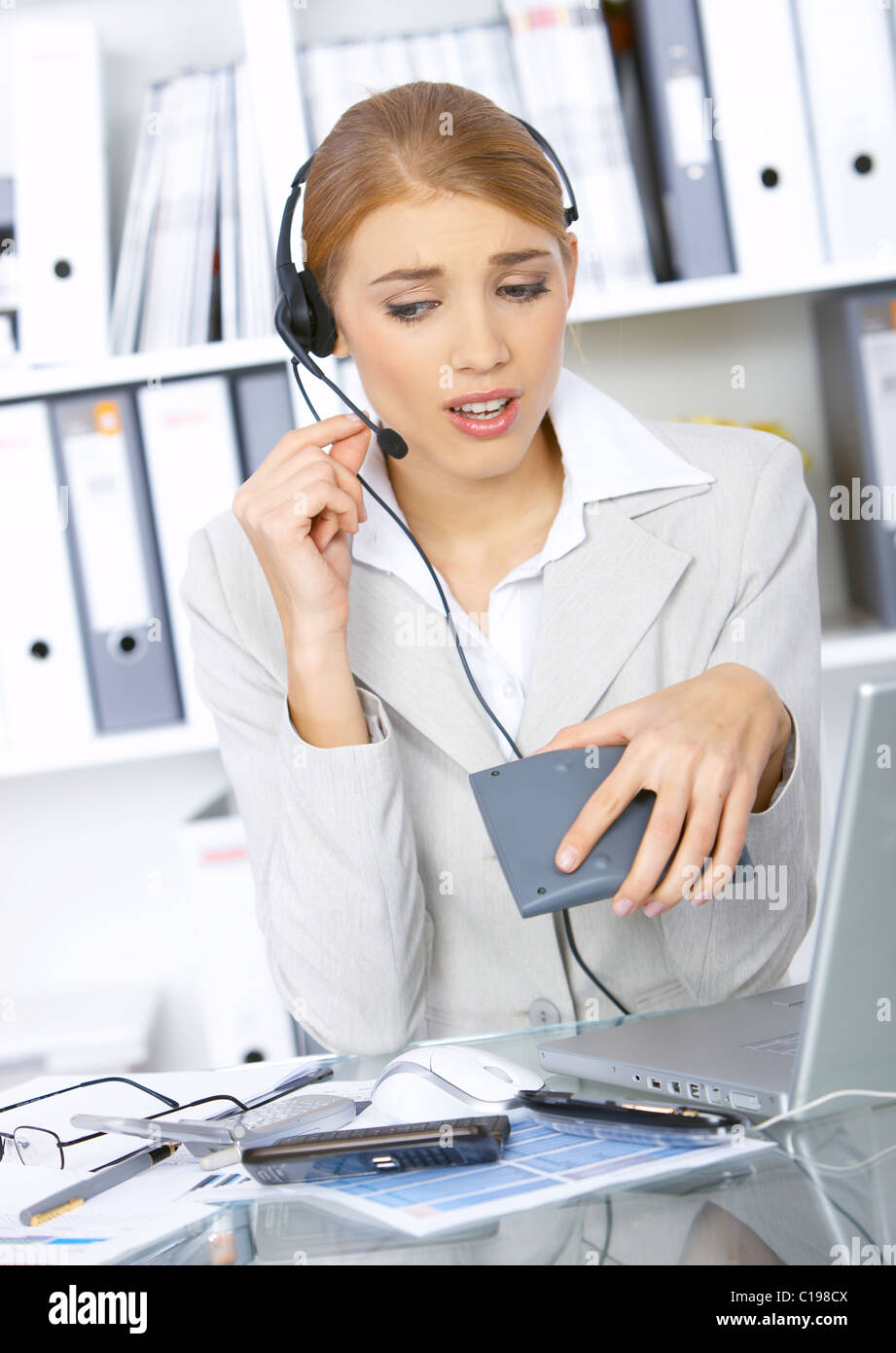 Business woman working in office, wearing headset Stock Photo - Alamy