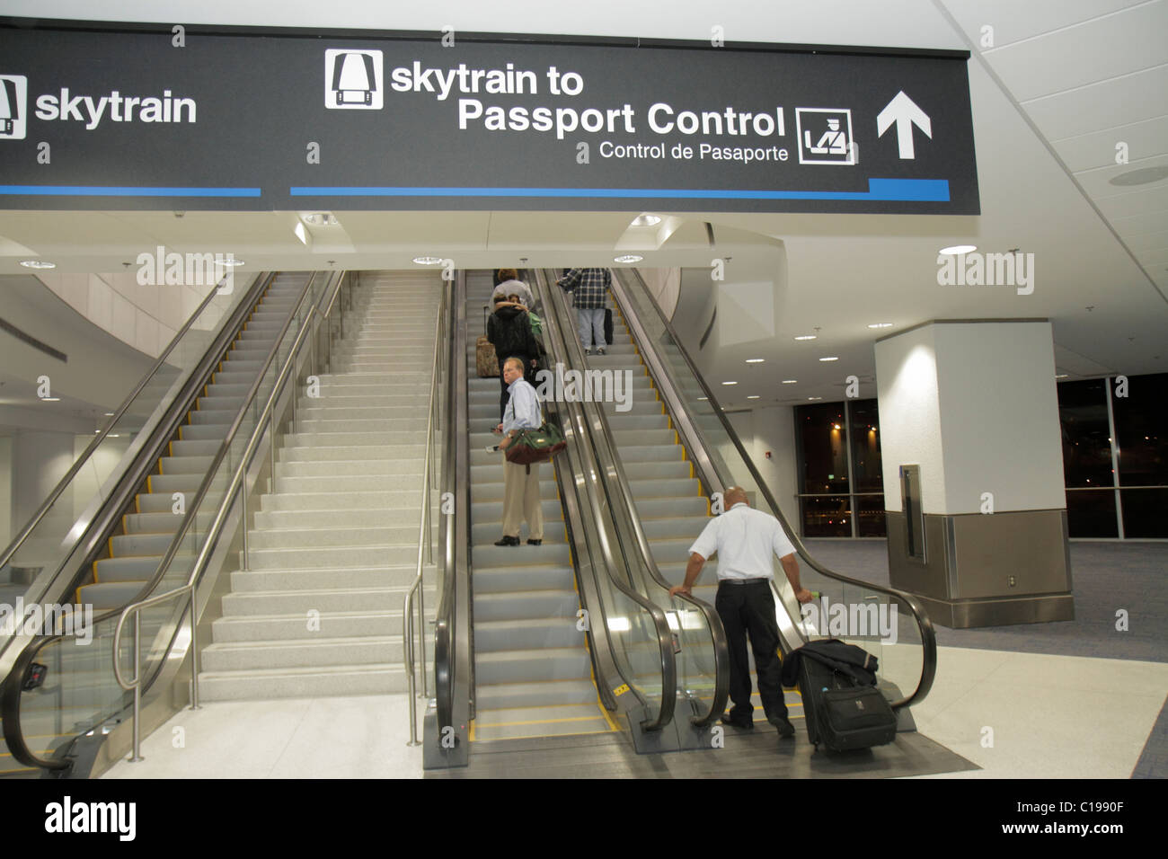 Miami Florida International Airport MIA,aviation,terminal,stairs,escalator,ascend,up,skytrain,Passport Control,international flight,bilingual,English, Stock Photo