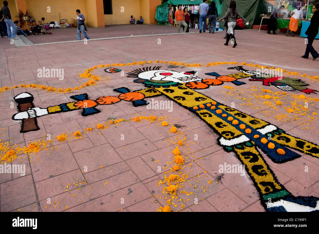 Drawing made with colored sand and flowers representing an Aztec warrior holding a head in Xochimilco, Mexico Stock Photo