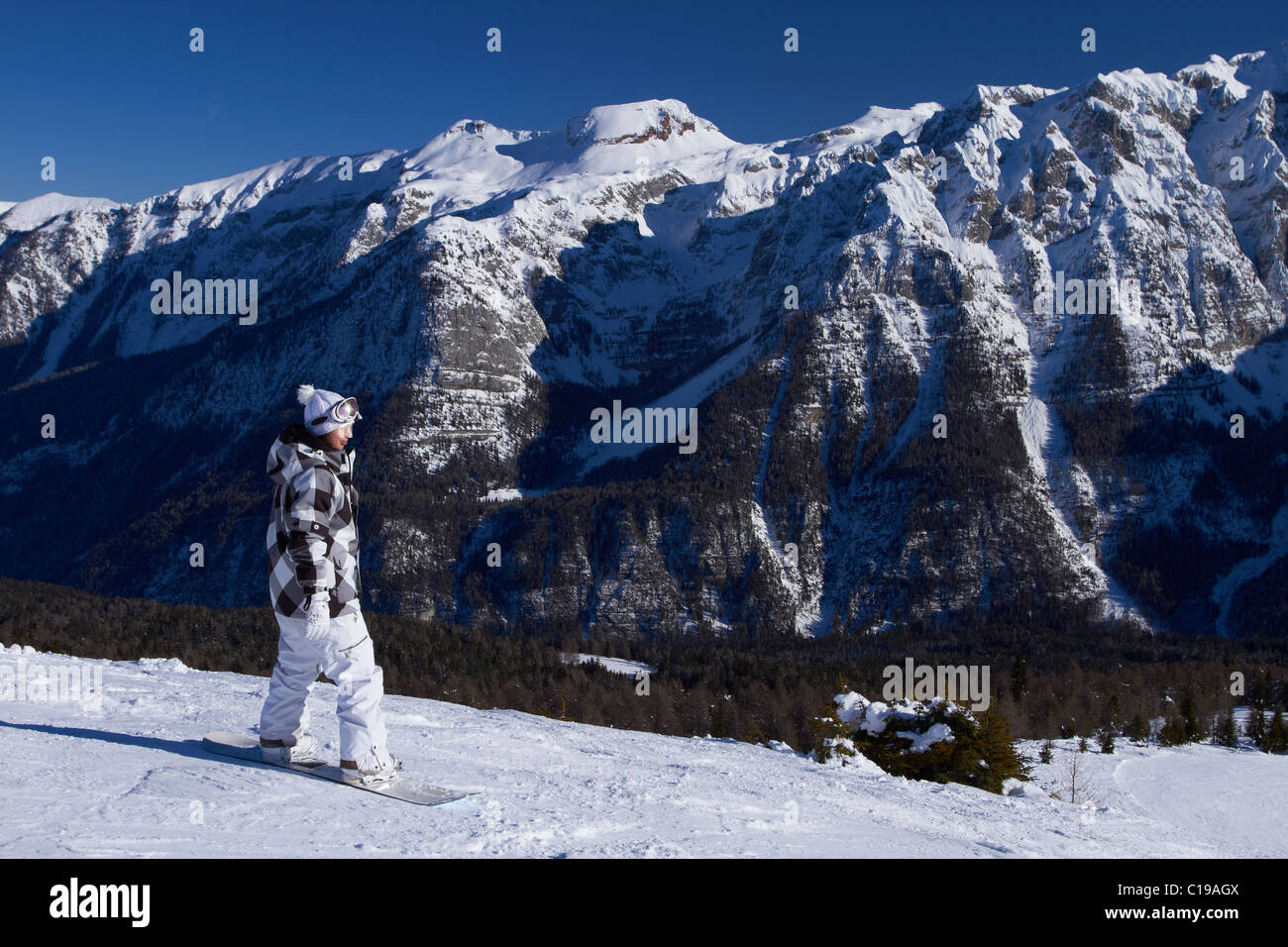 Female snowboarder is riding on snow in Dolomites Stock Photo - Alamy