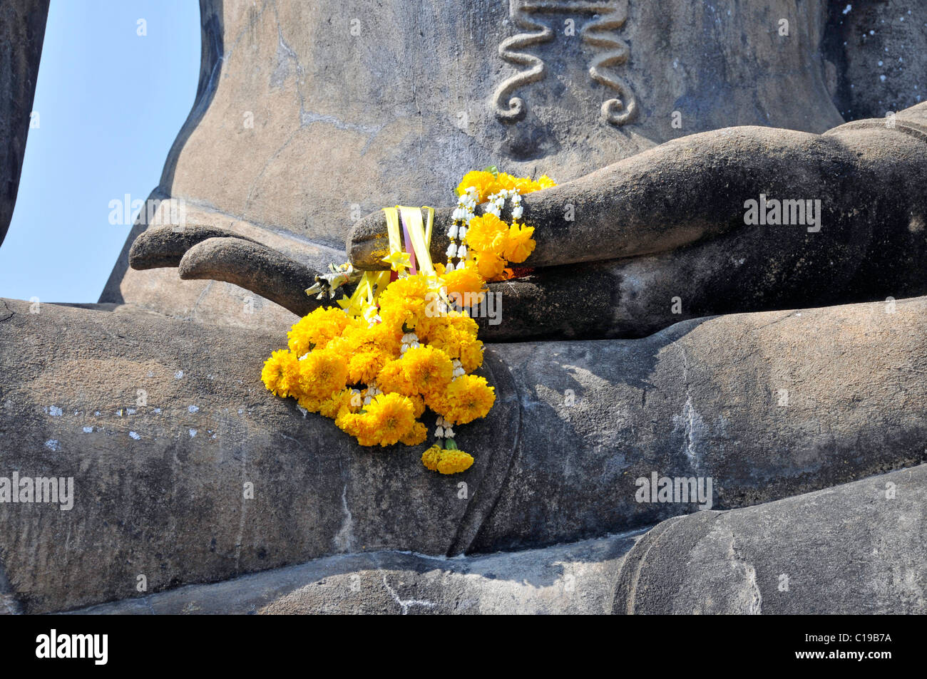 Hand of a Buddha statue decorated with a garland of flowers, Wat Mahathat, Sukhothai, Thailand, Asia Stock Photo