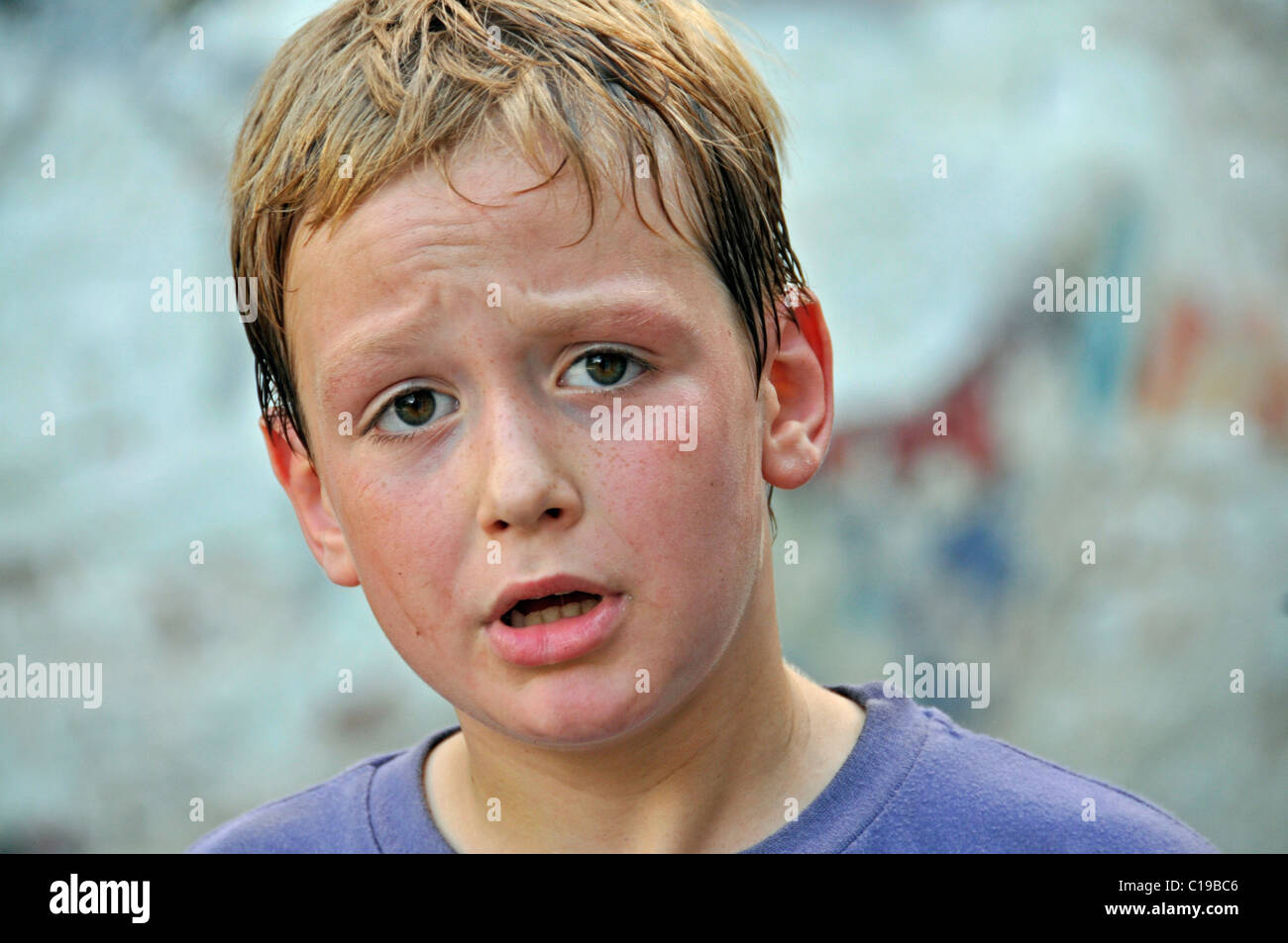 Sweaty 8-year-old boy, football yard in Cologne, North Rhine-Westphalia, Germany, Europe Stock Photo