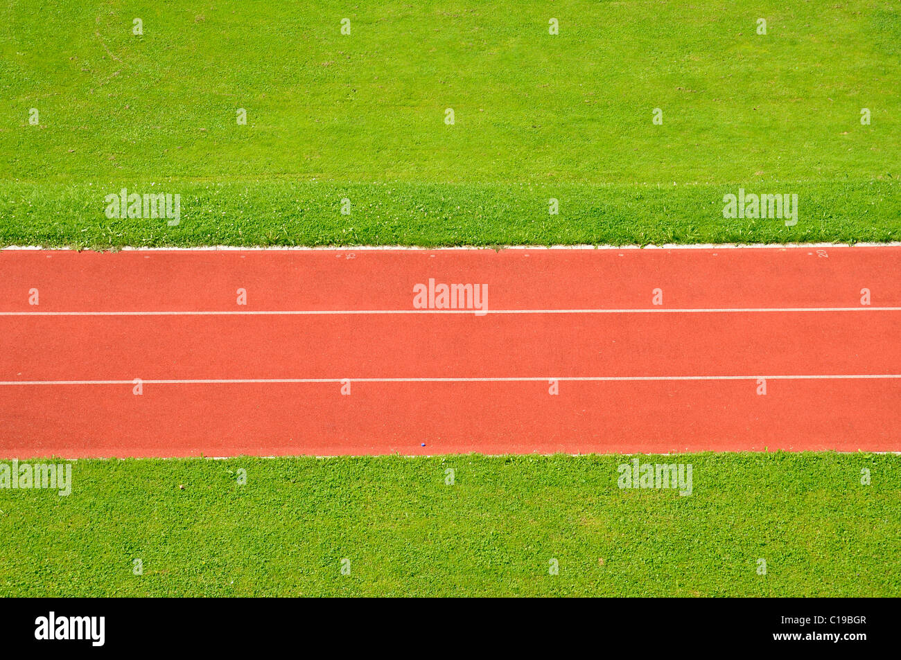 Straight running track, race track, sprint track, markings, red, green, lawn, sports ground Stock Photo