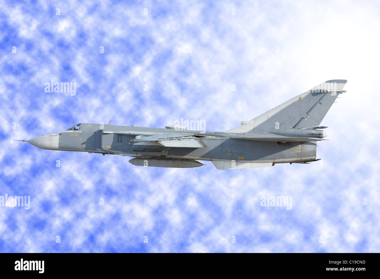 Military jet bomber Su-24 against clouds Stock Photo
