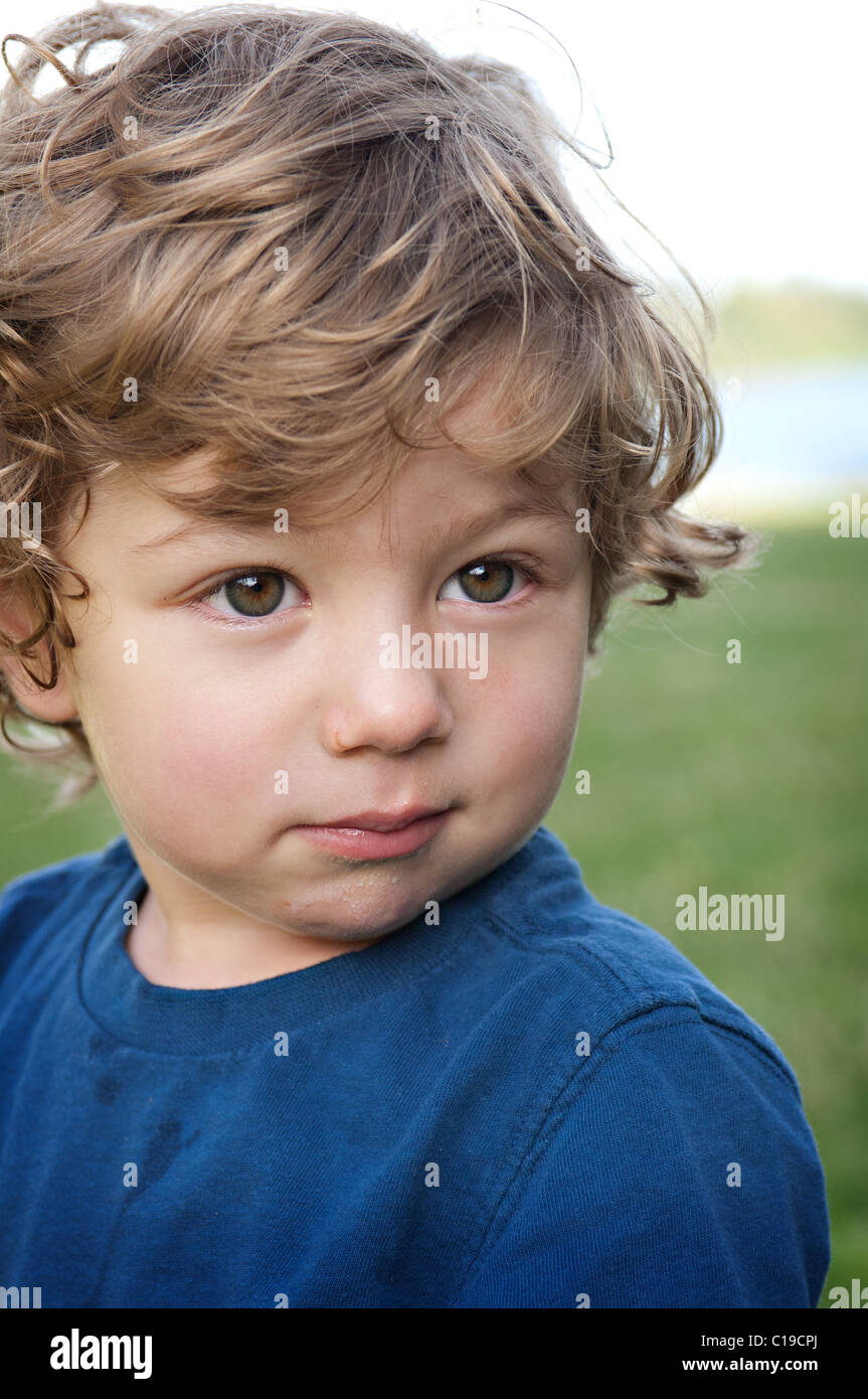 Portrait of a handsome boy who is listening with attention. Children
