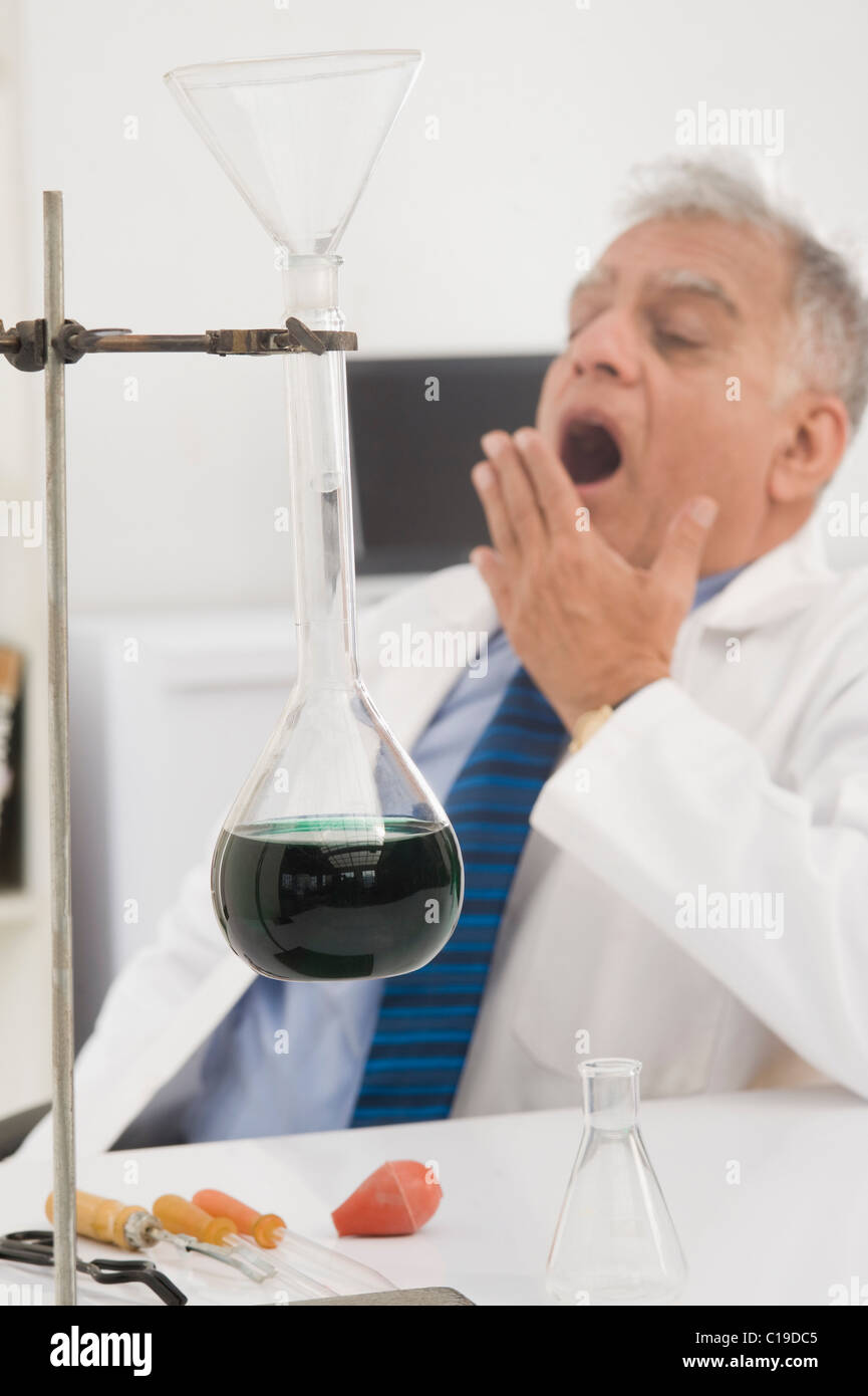 Scientist yawning in a laboratory Stock Photo