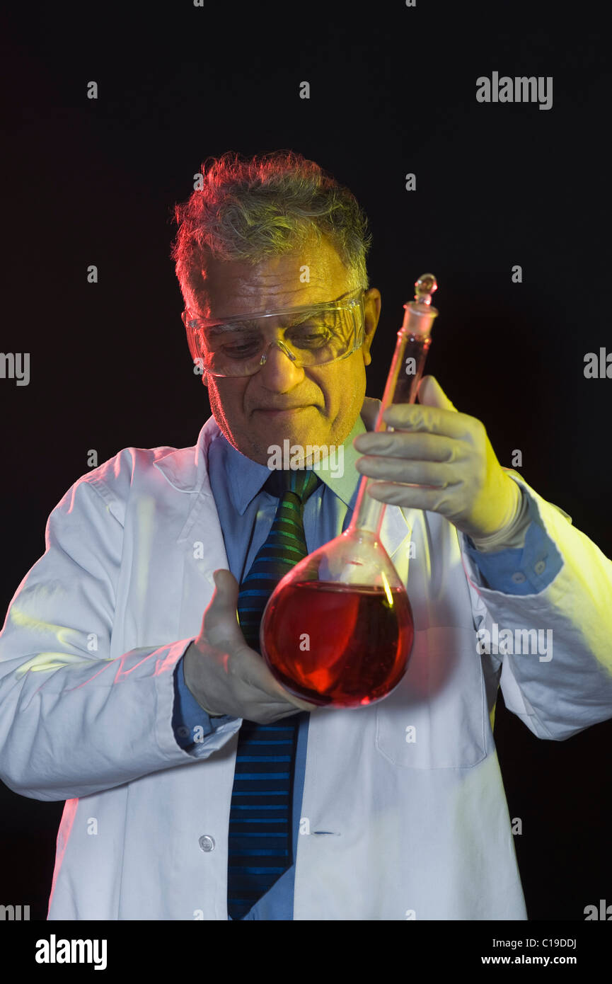 Scientist holding a chemical flask Stock Photo