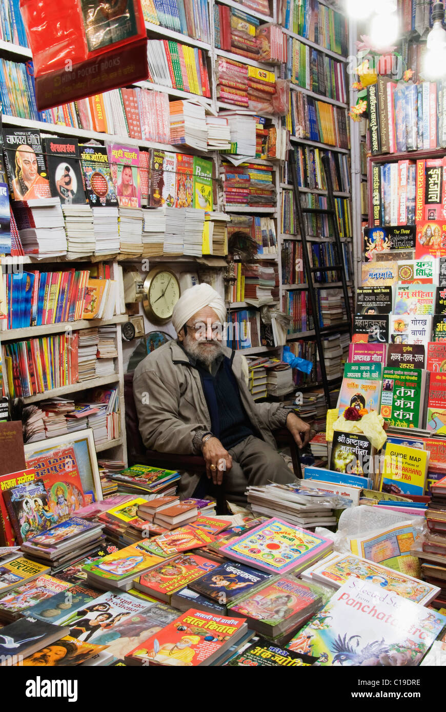 Vendor sitting in a bookstore, Haridwar, Uttarakhand, India Stock Photo