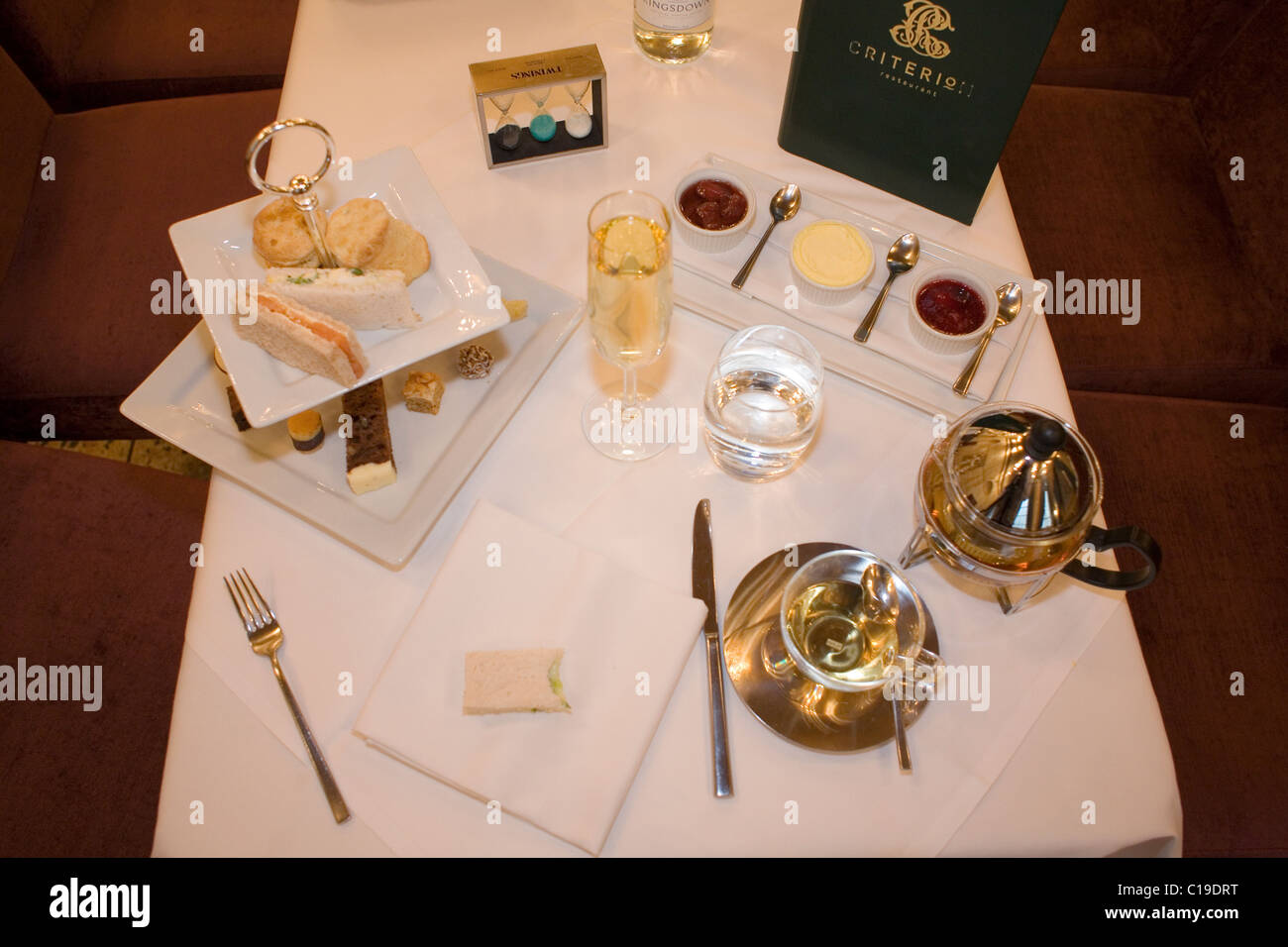 English afternoon tea, crust cut sandwiches jam & scones at the Criterion. Stock Photo
