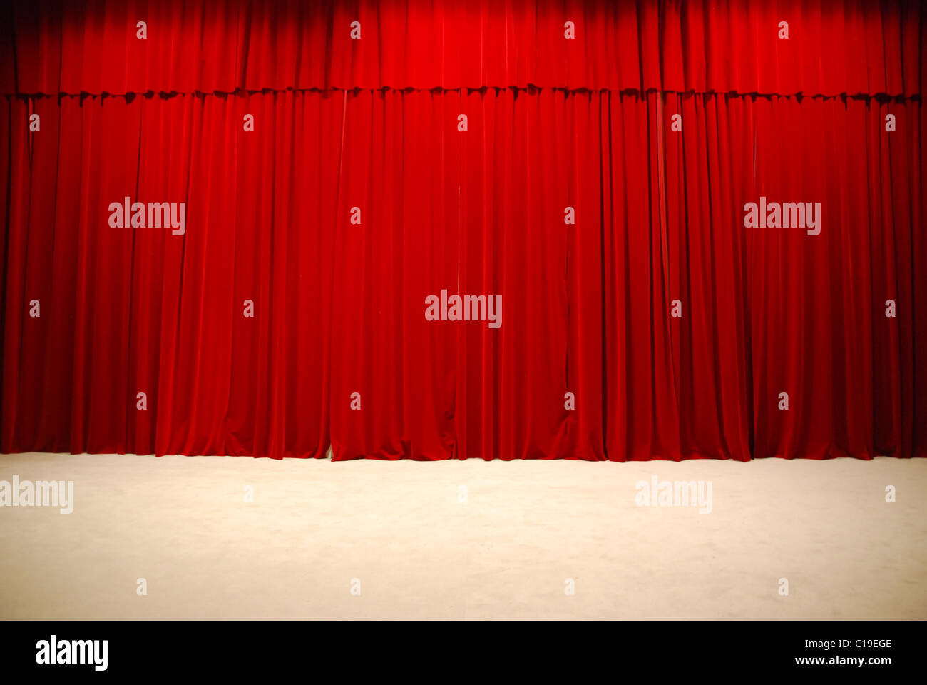 red draped theater stage curtains Stock Photo