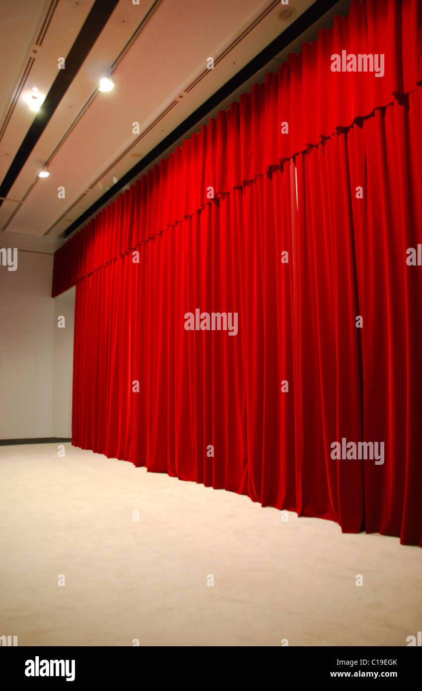 red draped theater stage curtains Stock Photo