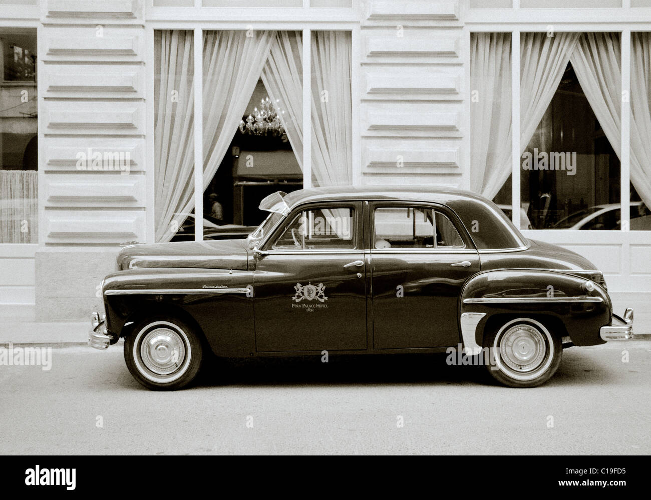 Classic car outside the Pera Palace Hotel in Istanbul in Turkey in Middle East Asia. Vintage Cars Wealth Wealthy Luxury Turkish Black and White Travel Stock Photo