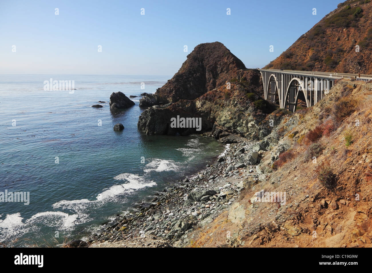 Majestic viaduct on the highway on the picturesque shore of the Pacific Ocean Stock Photo