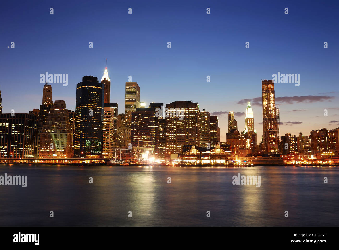 New York City Manhattan skyline at dusk over East River with ...