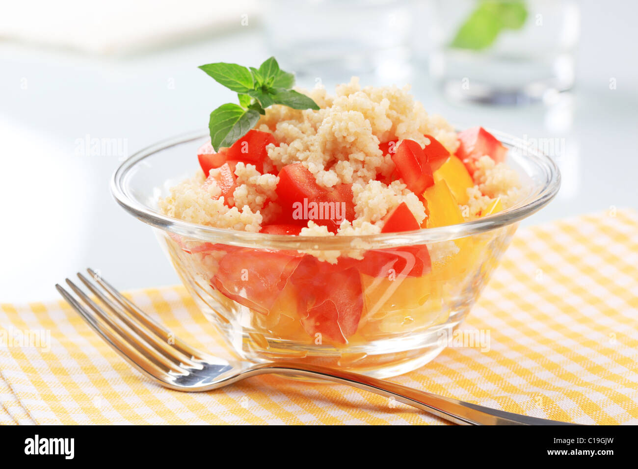 Bowl of fresh couscous salad and fork Stock Photo