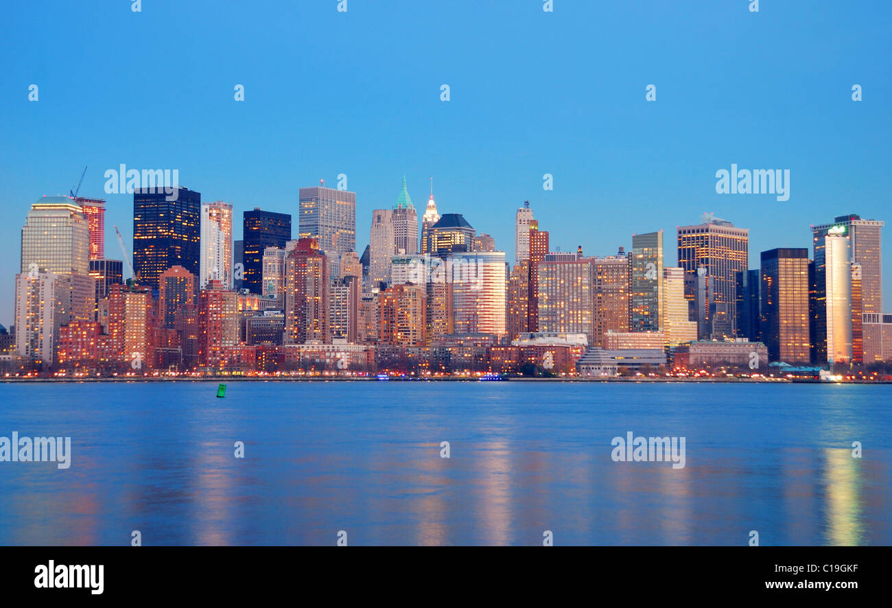Manhattan Skyline at dusk, New York City, with lights in offices ...