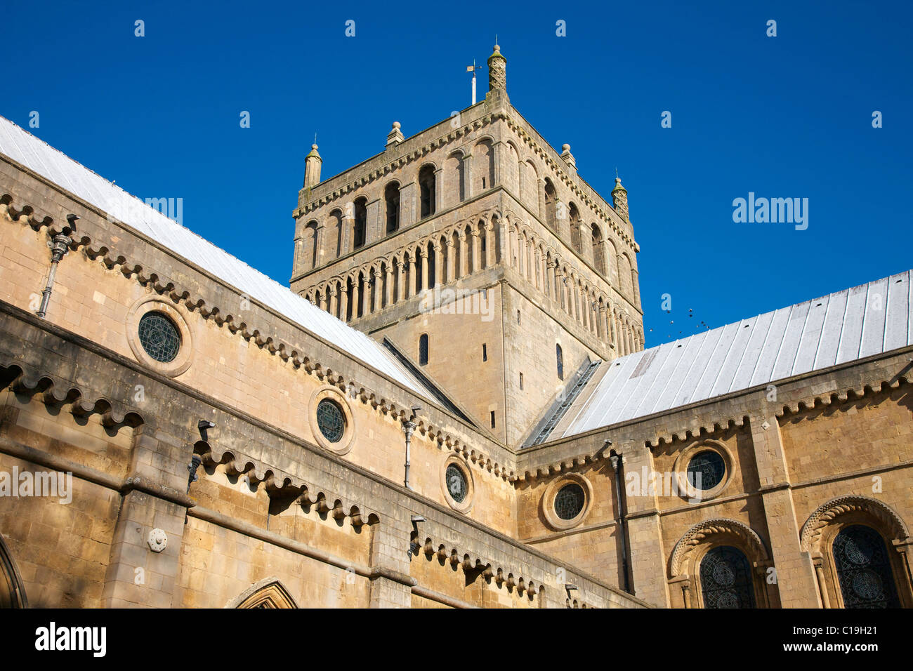 Southwell Minster in Nottinghamshire central transept tower with romanesque arched and roundel stained glass windows Stock Photo