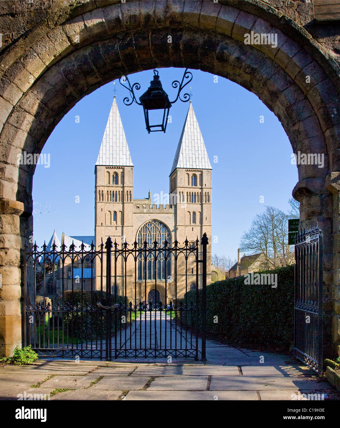 Southwell Minster in Nottinghamshire with unusual pepper pot towers glimpsed through the romanesque entrance gateway Stock Photo