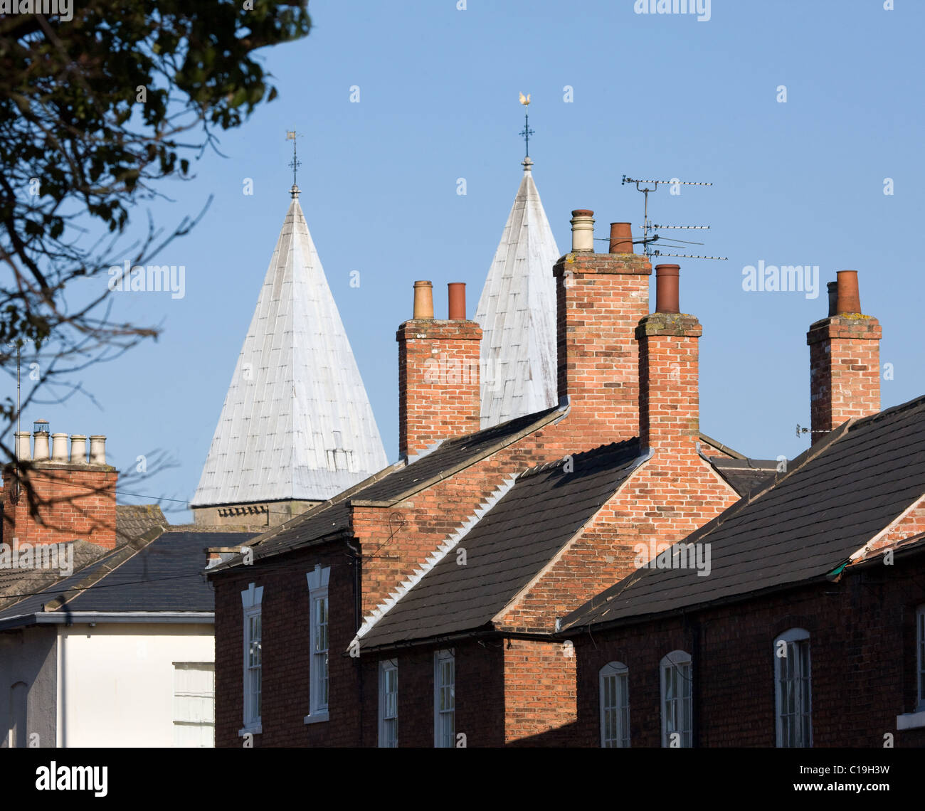 Southwell Minster in Nottinghamshire with its unusual pepper pot towers peering over surrounding houses Stock Photo