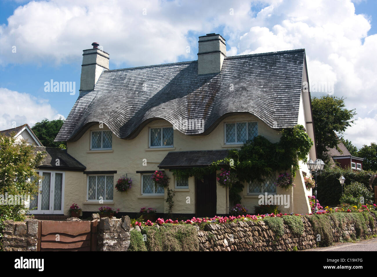 House in Croyde, North Devon, with wavy tiled roof in imitation of thatch Stock Photo