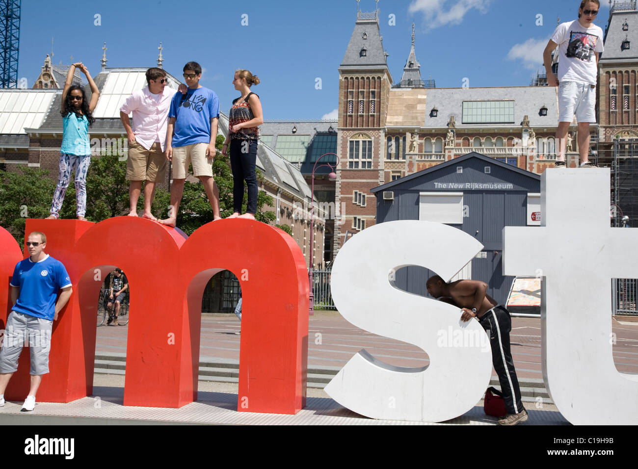 People climbing on large alphabetical sculpture. New Rijksmuseum building in Museum Square. Amsterdam. Netherlands. Stock Photo