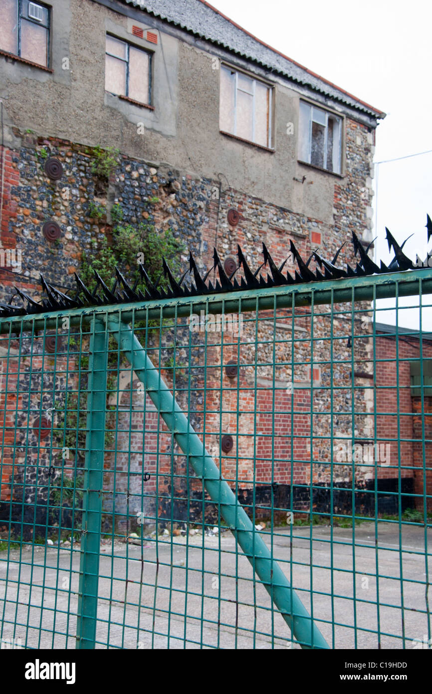 security spikes on top of Brick wall gate Stock Photo Alamy