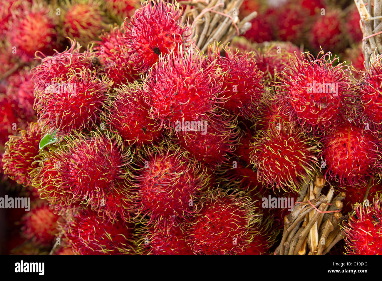 Rambutan on Fruit Stand in Tropical Country Stock Photo