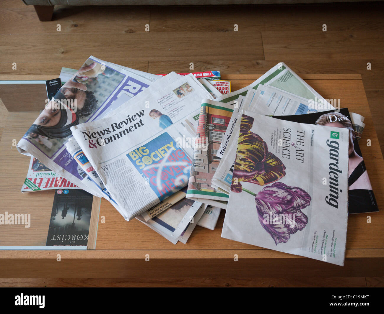 Newspapers scattered on a coffee table Stock Photo Alamy