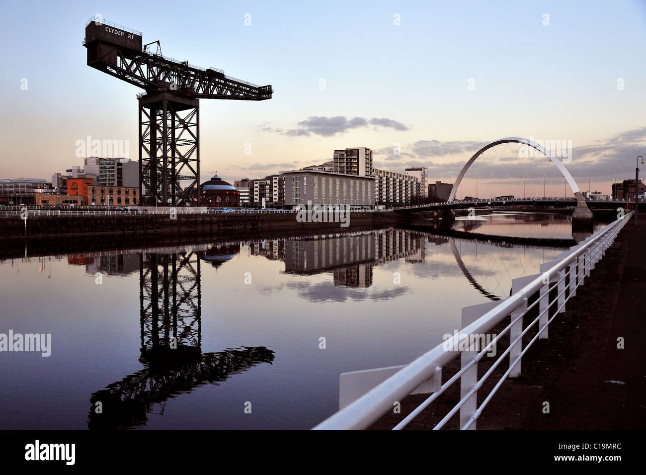 Dusk over the River Clyde, taking in the Finnieston Crane and the Cldye Arc, otherwise known as the Squinty Bridge Stock Photo
