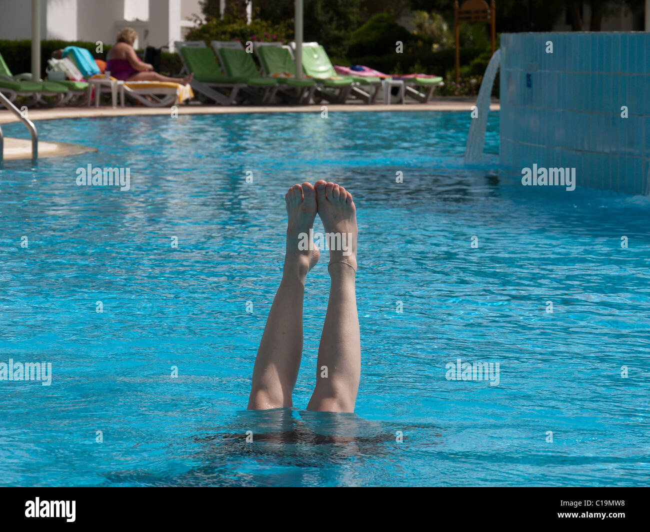 Handstand in swimming pool legs hi-res stock photography and images - Alamy