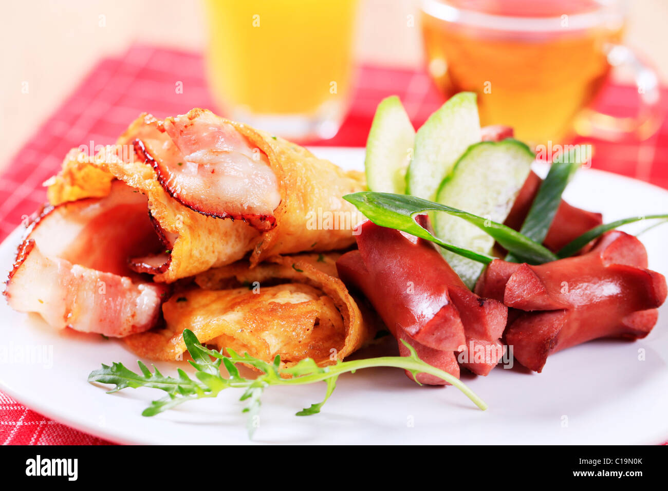 Fried egg omelet with bacon and sausages Stock Photo Alamy