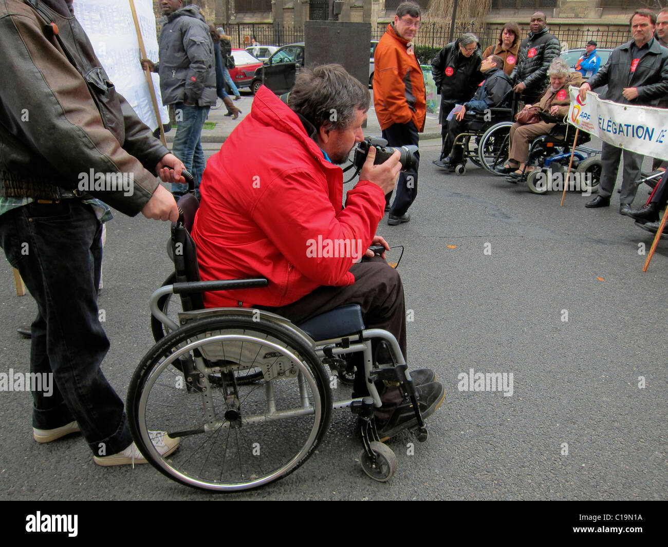 Paris, France, Handicapped Man, Photographer, Taking Pictures at Public Demonstration Protesting Against Forced Housing Expulsions, in Wheelchairs photographer protests Stock Photo