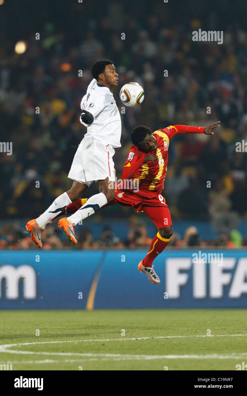Robbie Findley of the United States (l) and Anthony Annan of Ghana (r) jump for the ball during a FIFA World Cup R16 match. Stock Photo
